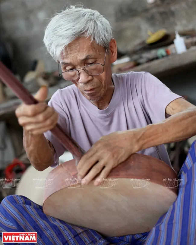 Hình ảnh nghệ nhân Đào Ngọc Soạn miệt mài chế tác nhạc cụ dân tộc