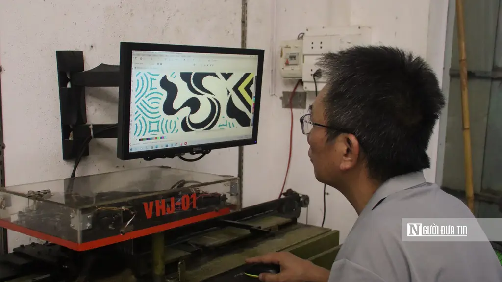 Nghệ nhân Đỗ Văn Hiển vẽ hoa văn trên máy tính